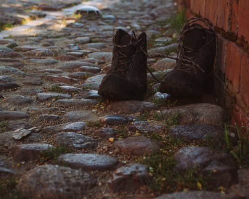 Walking shoes on a pavement during sunset