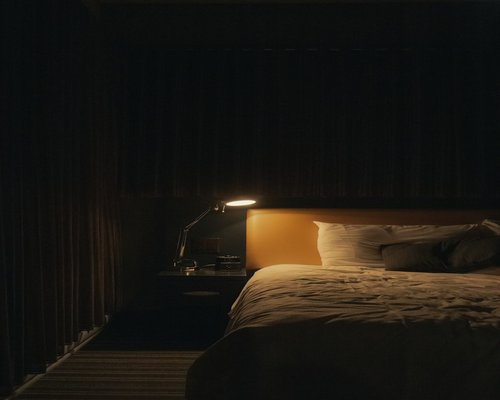 A dimly lit room with a book on the nightstand